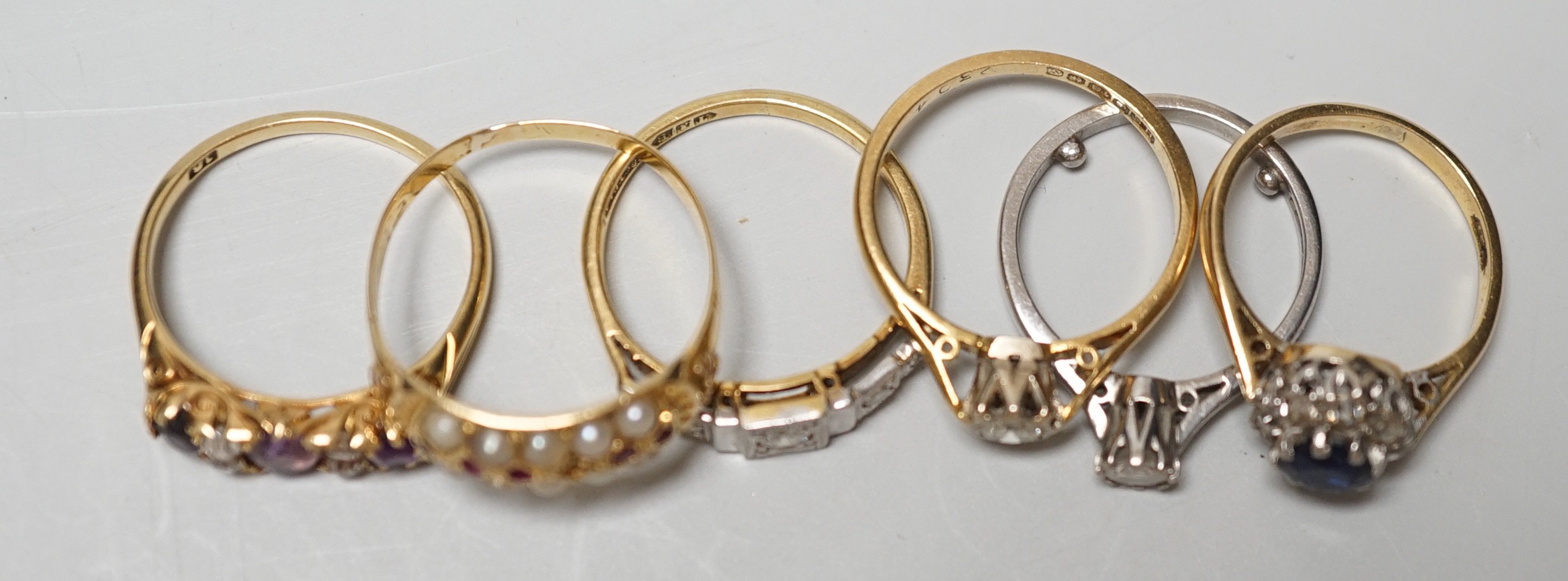 Five assorted 18ct and gem set rings, including 1920's millegrain diamond set, two solitaire diamond rings, sapphire and diamond cluster and amethyst and diamond half hoop (stone replaced and repair) and one other yellow